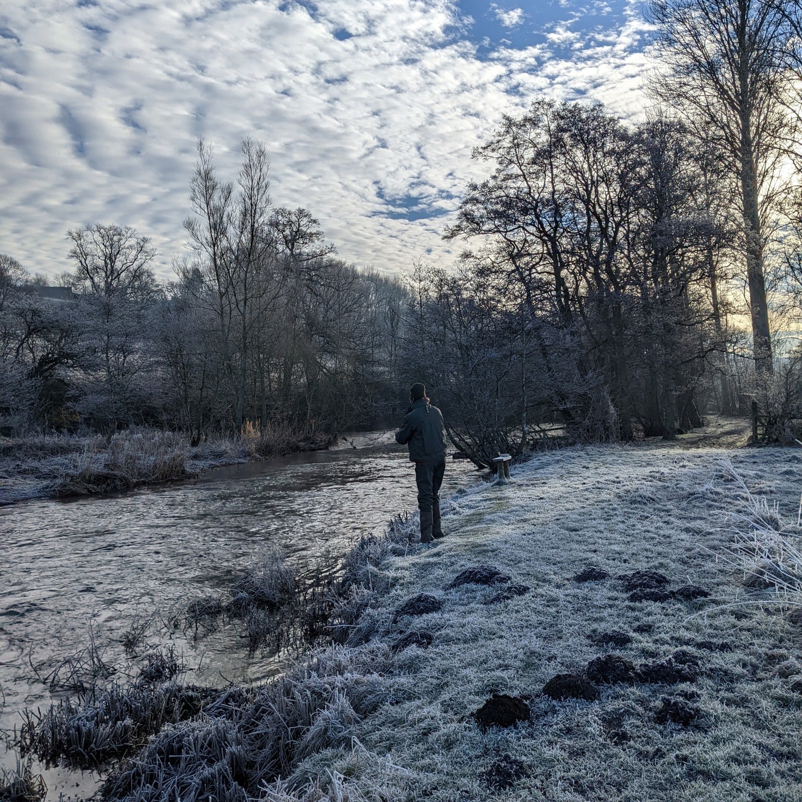 Grayling fishing beside a frost-covered river